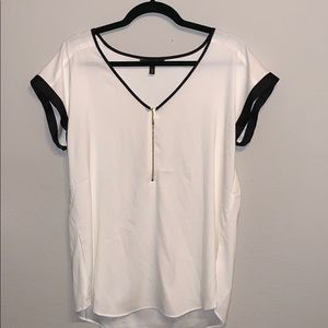 Off white blouse with black trim, gold zipper